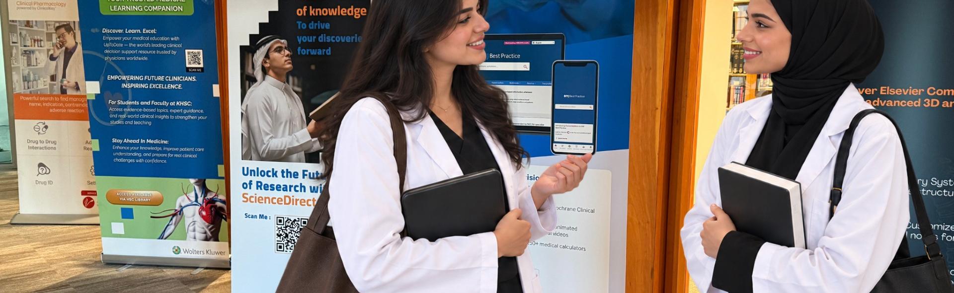 Two female medical students in lab coats conversating
